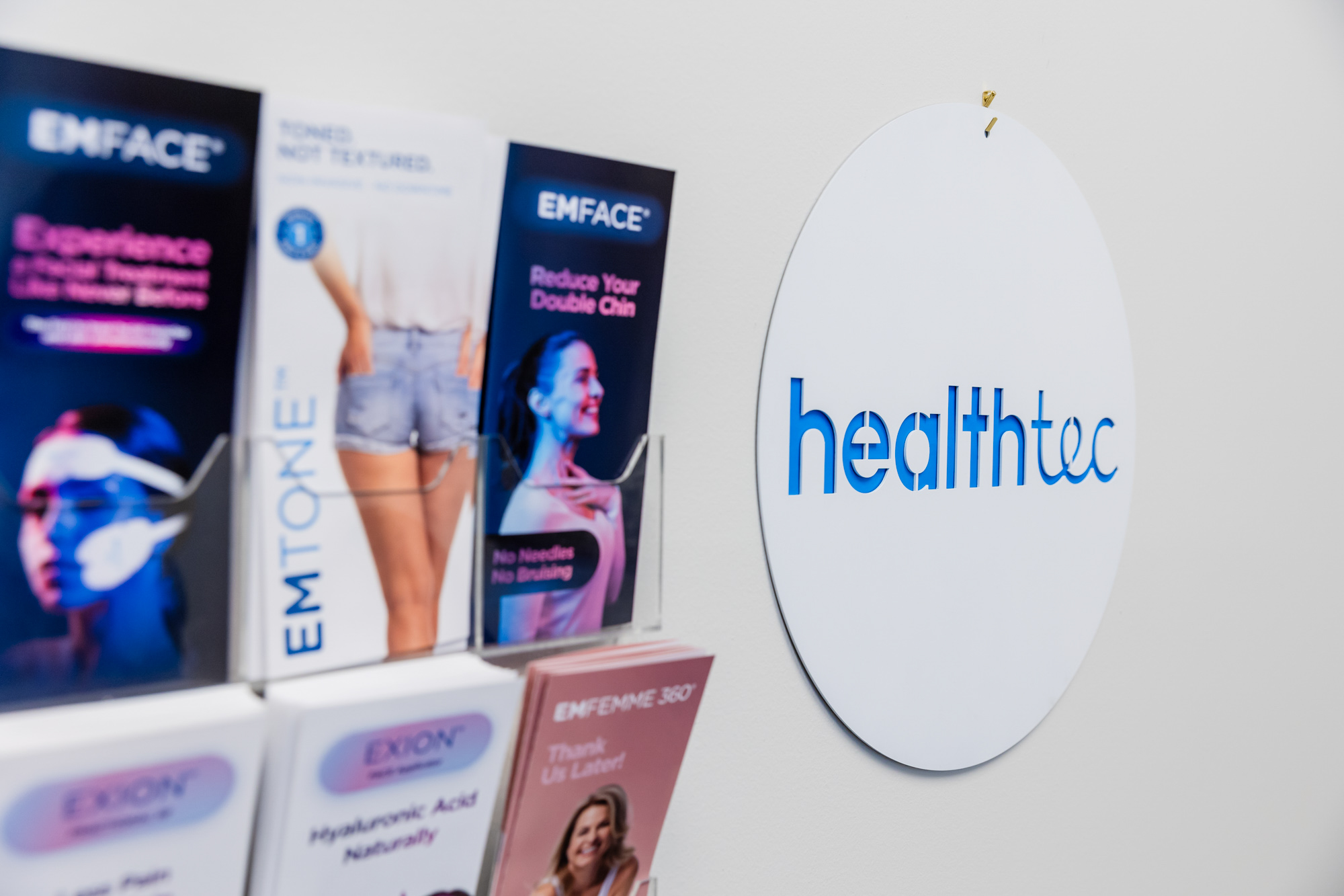 A sign for healthec placed beside informational pamphlets about their selection of body contouring treatment in Abilene.