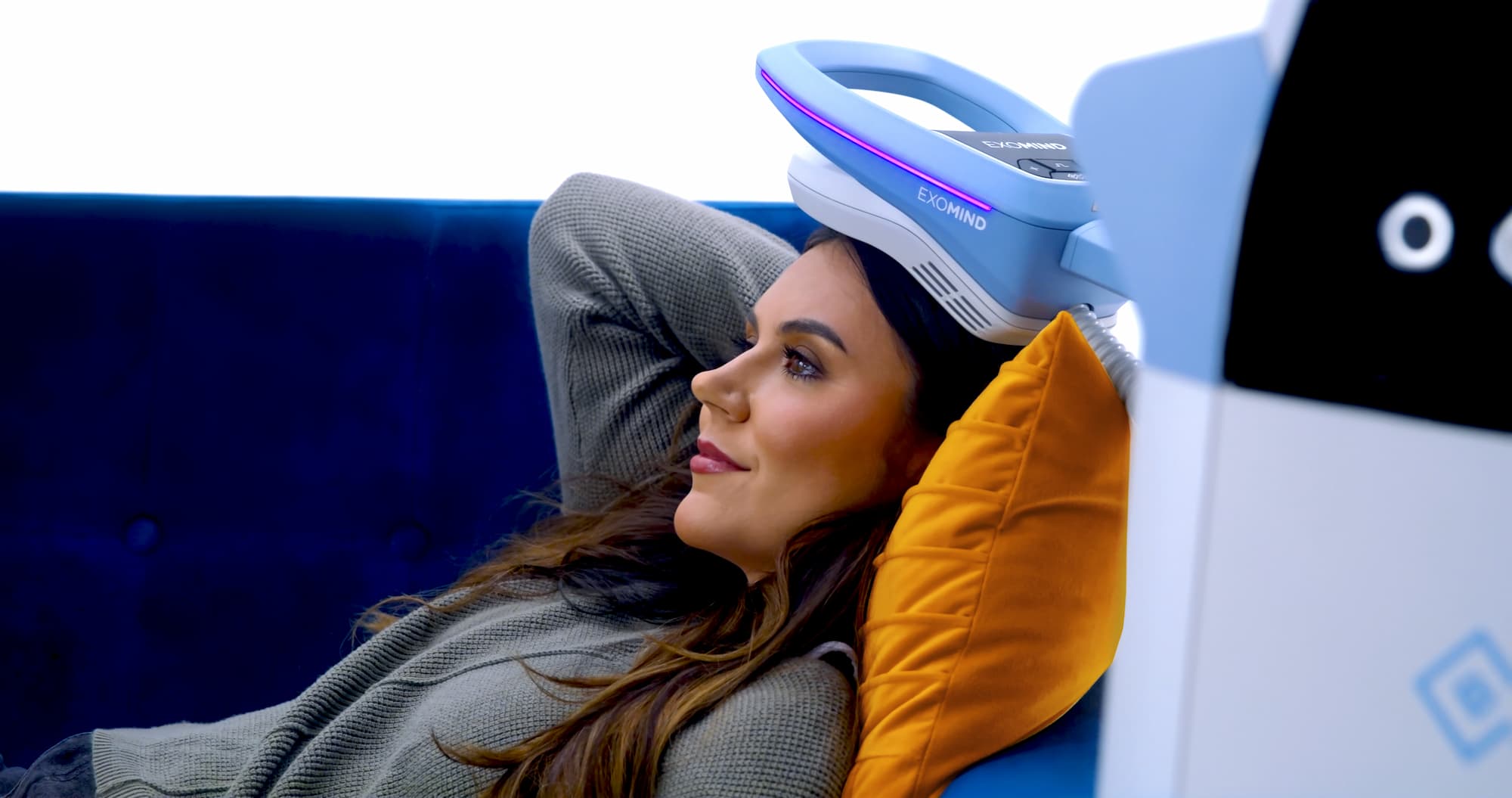 A woman lying on a couch, receiving an Exomind treatment, the best treatment for anxiety in Abilene